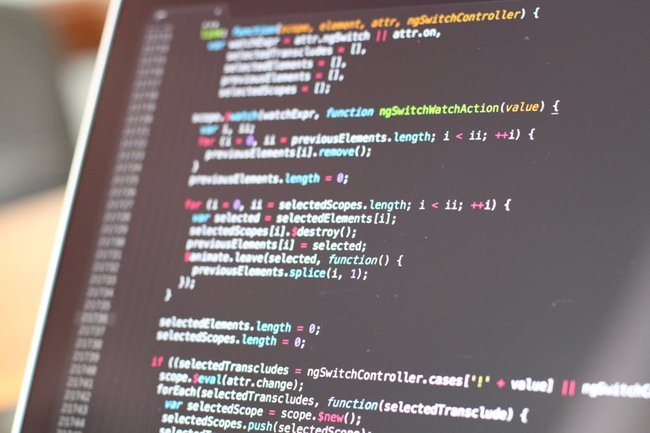 A photograph showing a computer screen displaying lines of CSS code in a dark-themed code editor. The code includes properties such as 'background-color,' 'font-family,' 'margin,' and 'border-box,' in